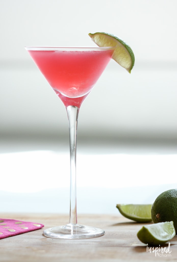 long stem martini glass filled with cranberry lime cosmo drink