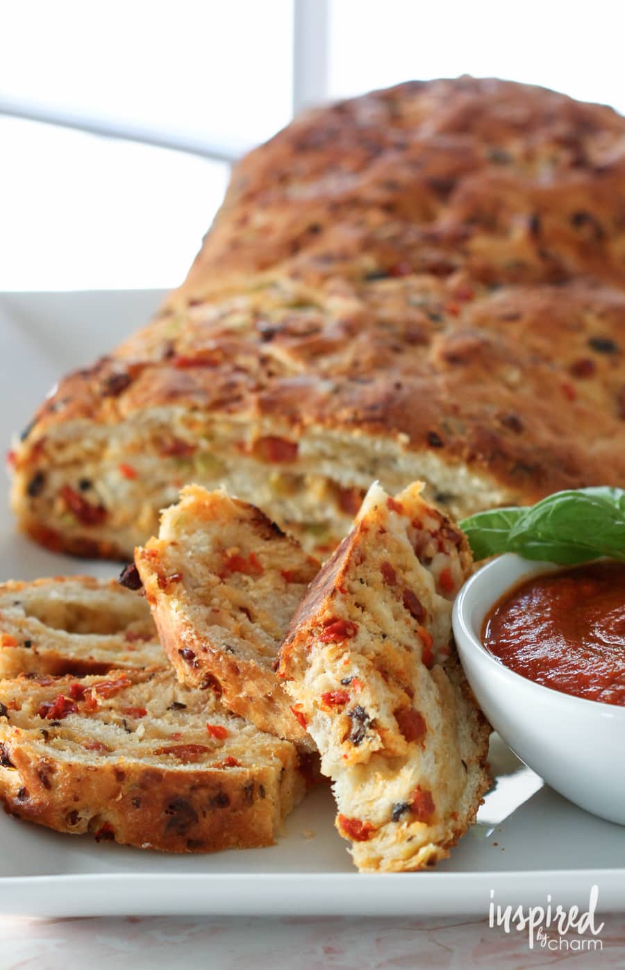 pizza bread with marinara sauce served on a white plate. 