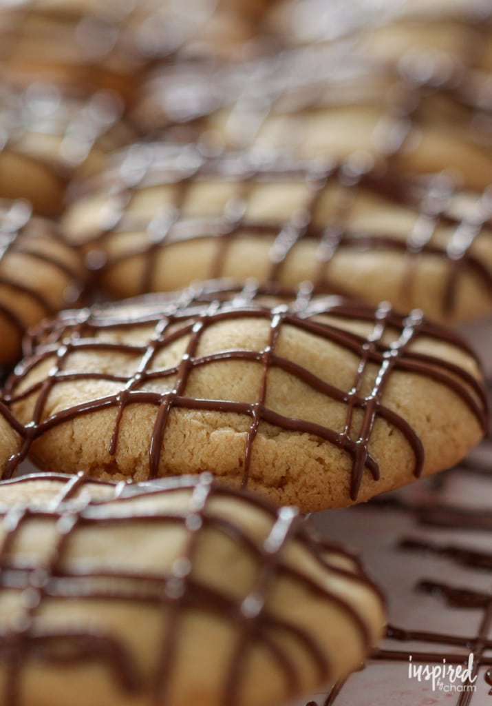 close up of stuffed peanut butter cookies drizzled with chocolate.