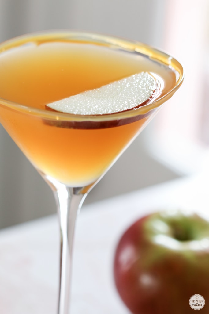 up close shot of an apple slice floating in a caramel apple martini 