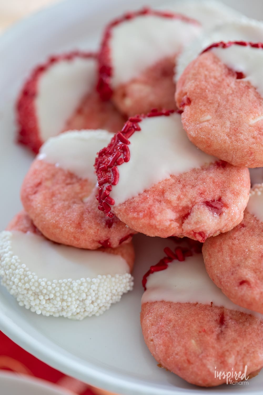 White Chocolate Cherry Shortbread Cookies stacked on a plate.