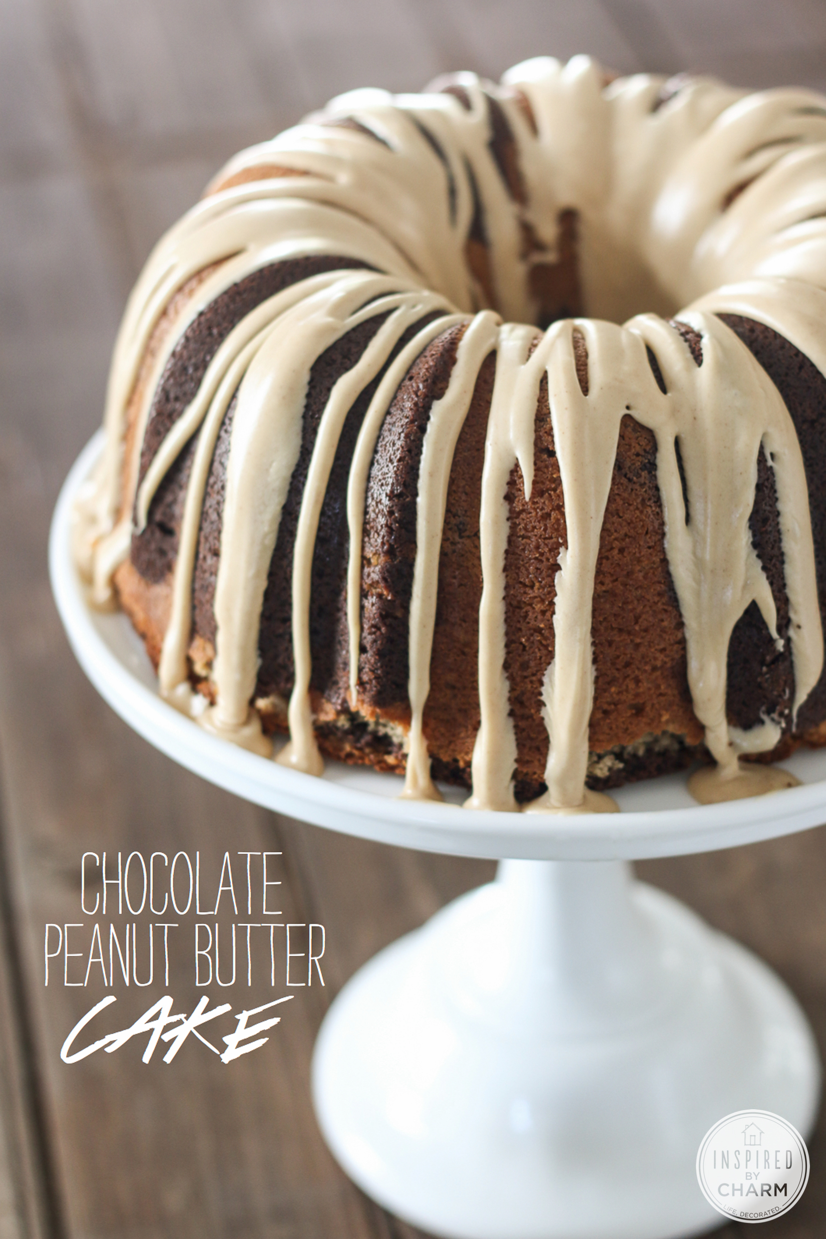 chocolate cake with peanut butter glaze on a cake stand. 