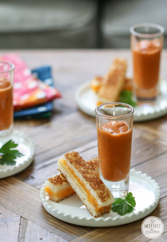 plates with mini grilled cheese sandwich strips served with a small glass of tomato basil soup. 
