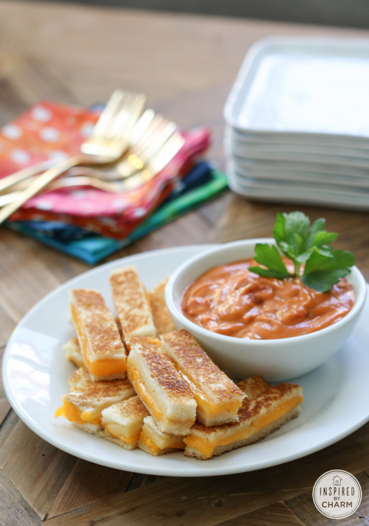 plate of mini grilled cheese strips and a bowl of tomato basil soup.