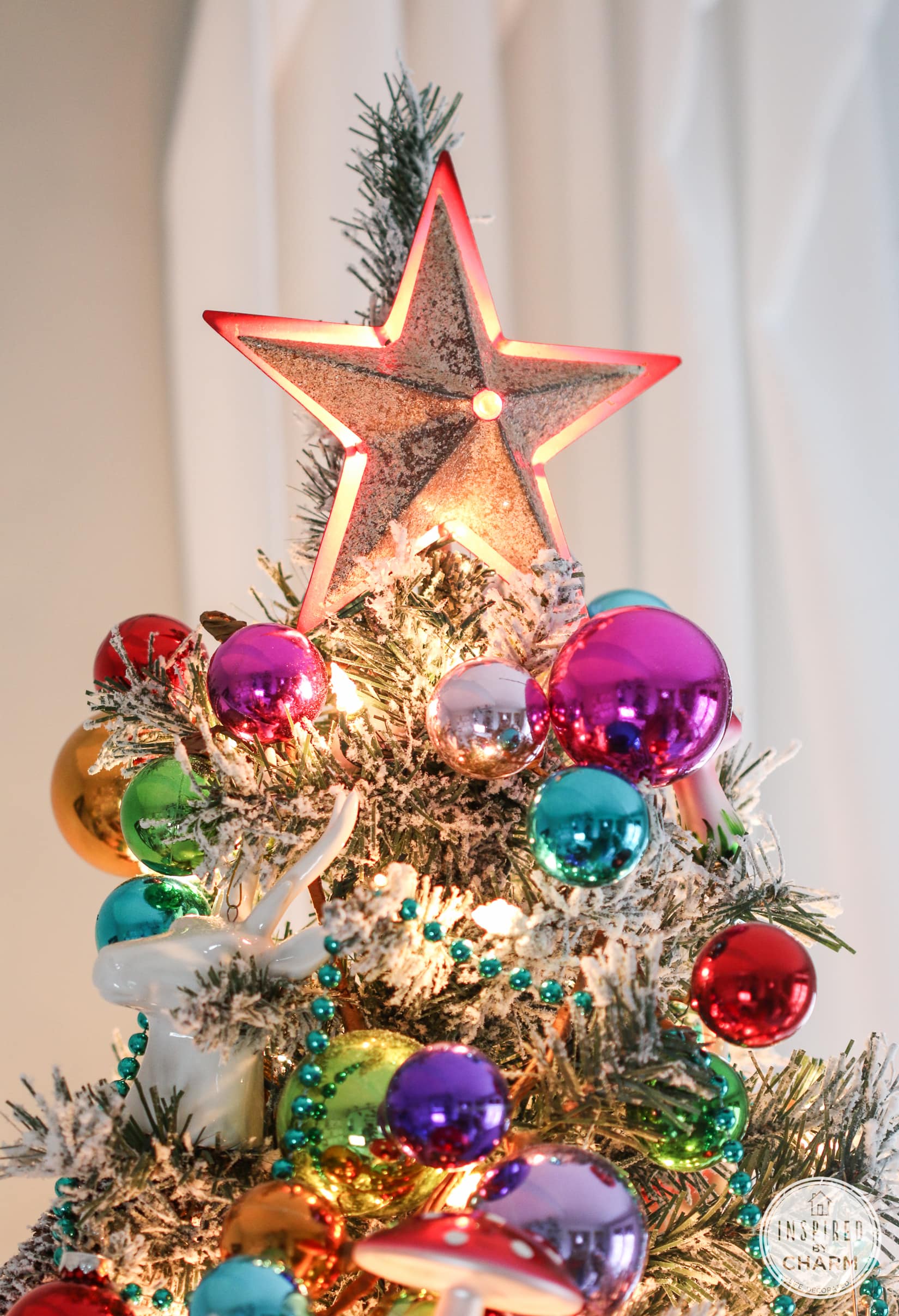 christmas tree topper with colorful ornaments. 
