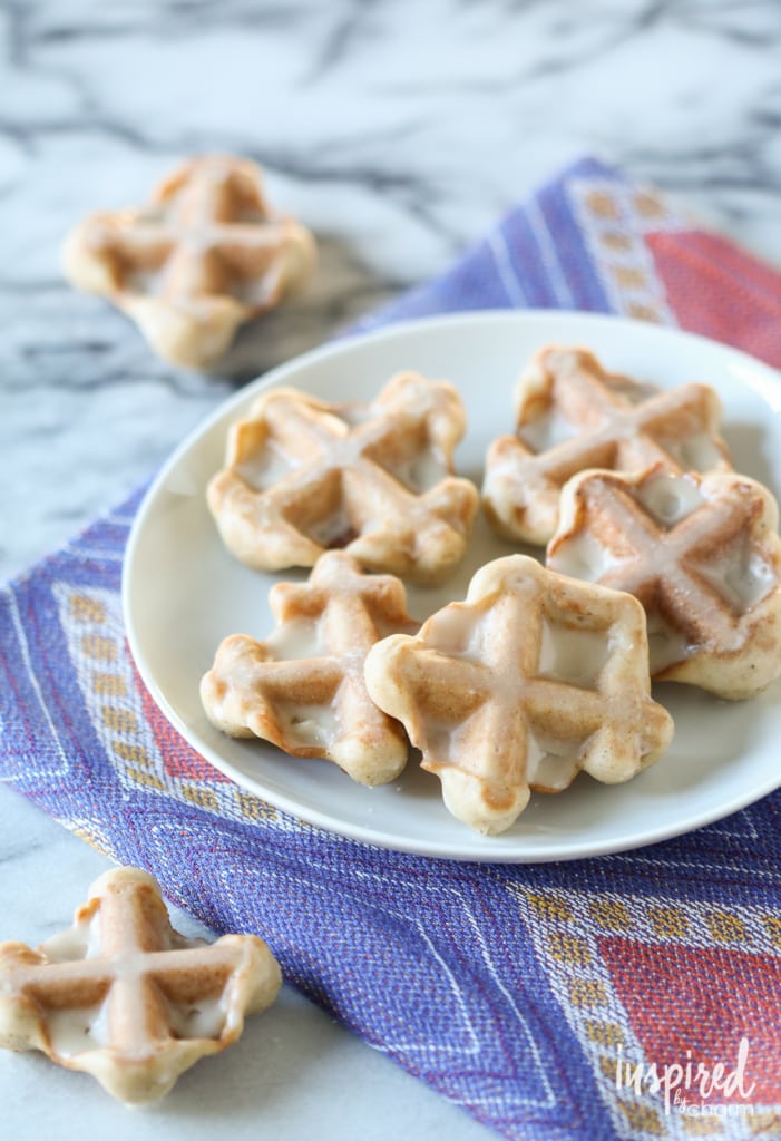 maple glazed waffle cookies stacked on plate. 