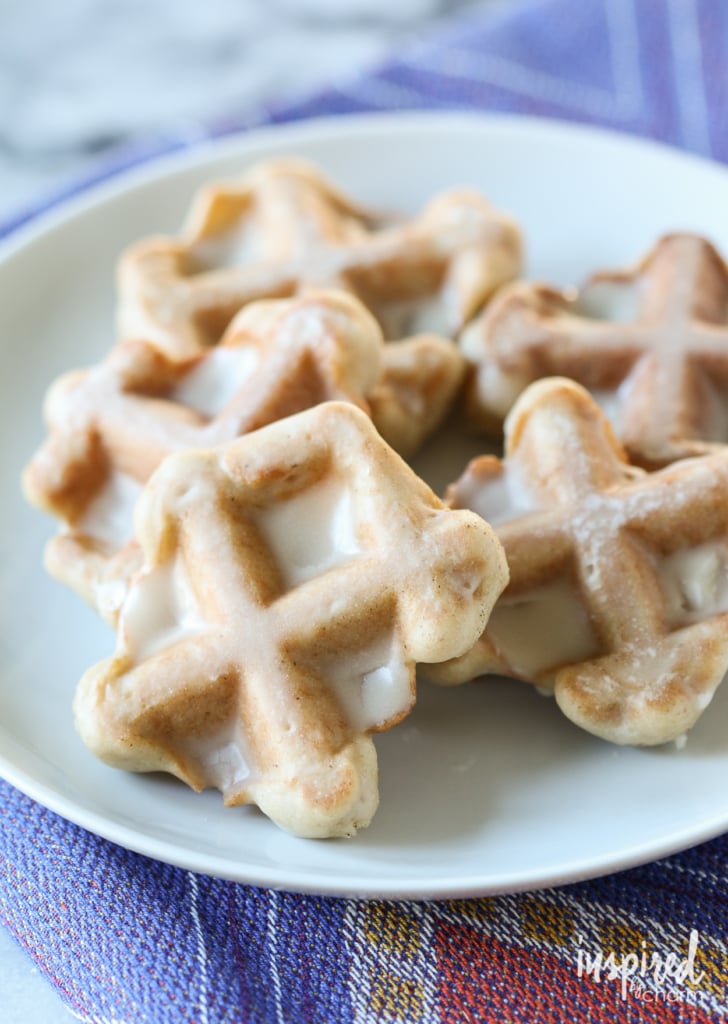 maple glazed waffle cookies stacked on plate. 