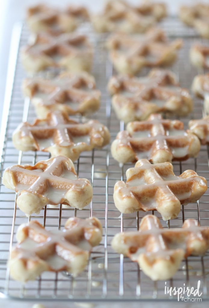 maple glazed waffle cookies on a cooling rack. 