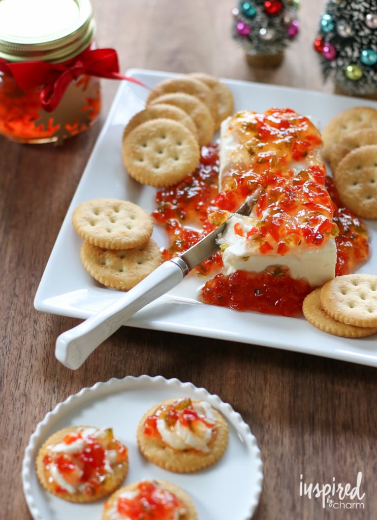 knife slicing into cream cheese cracker appetizer