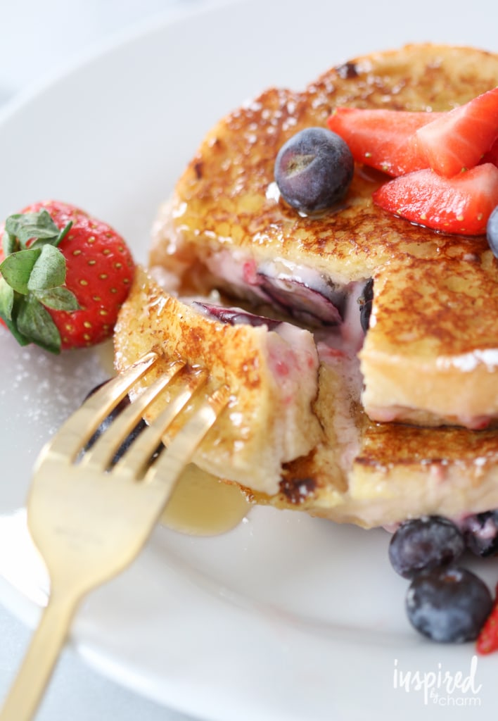 a bite of cream cheese filled French toast on a fork