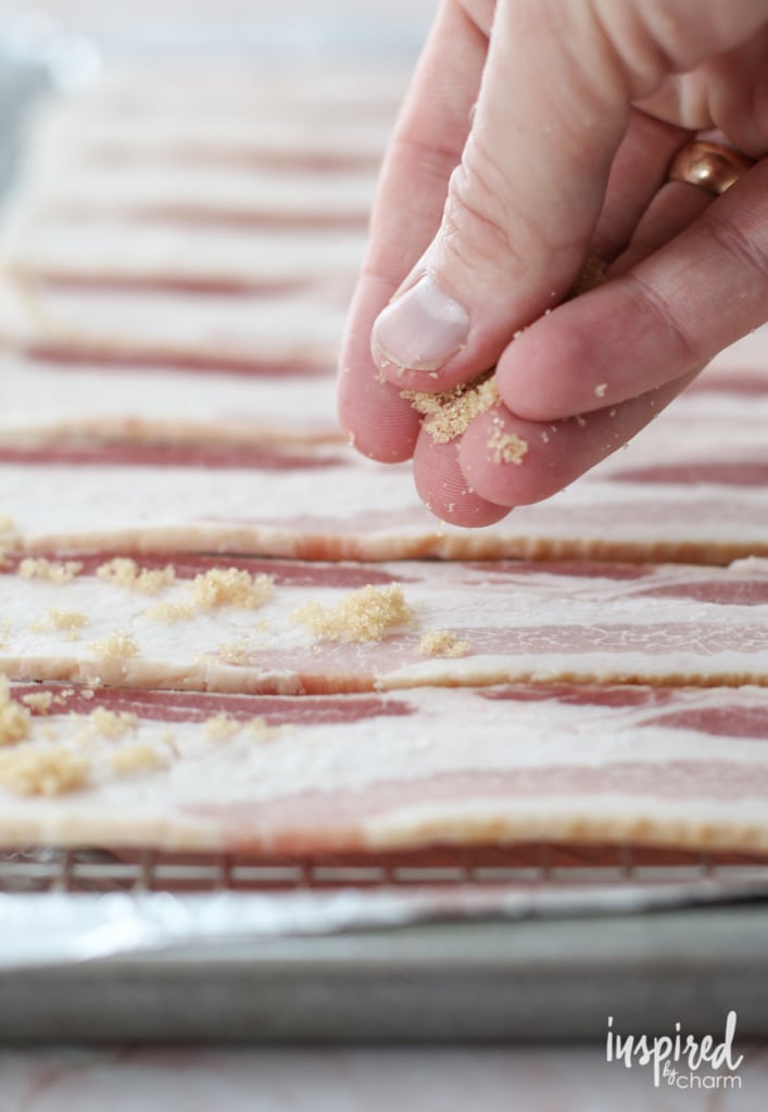 sprinkling brown sugar on raw bacon