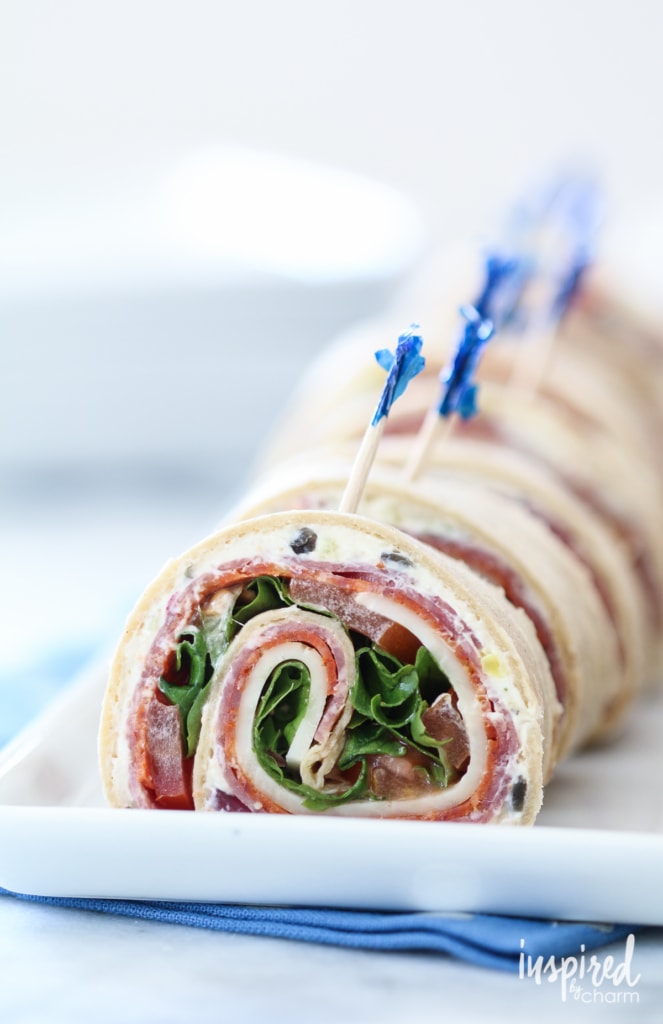 Italian Sub Pinwheel Sandwiches with toothpick on a plate.