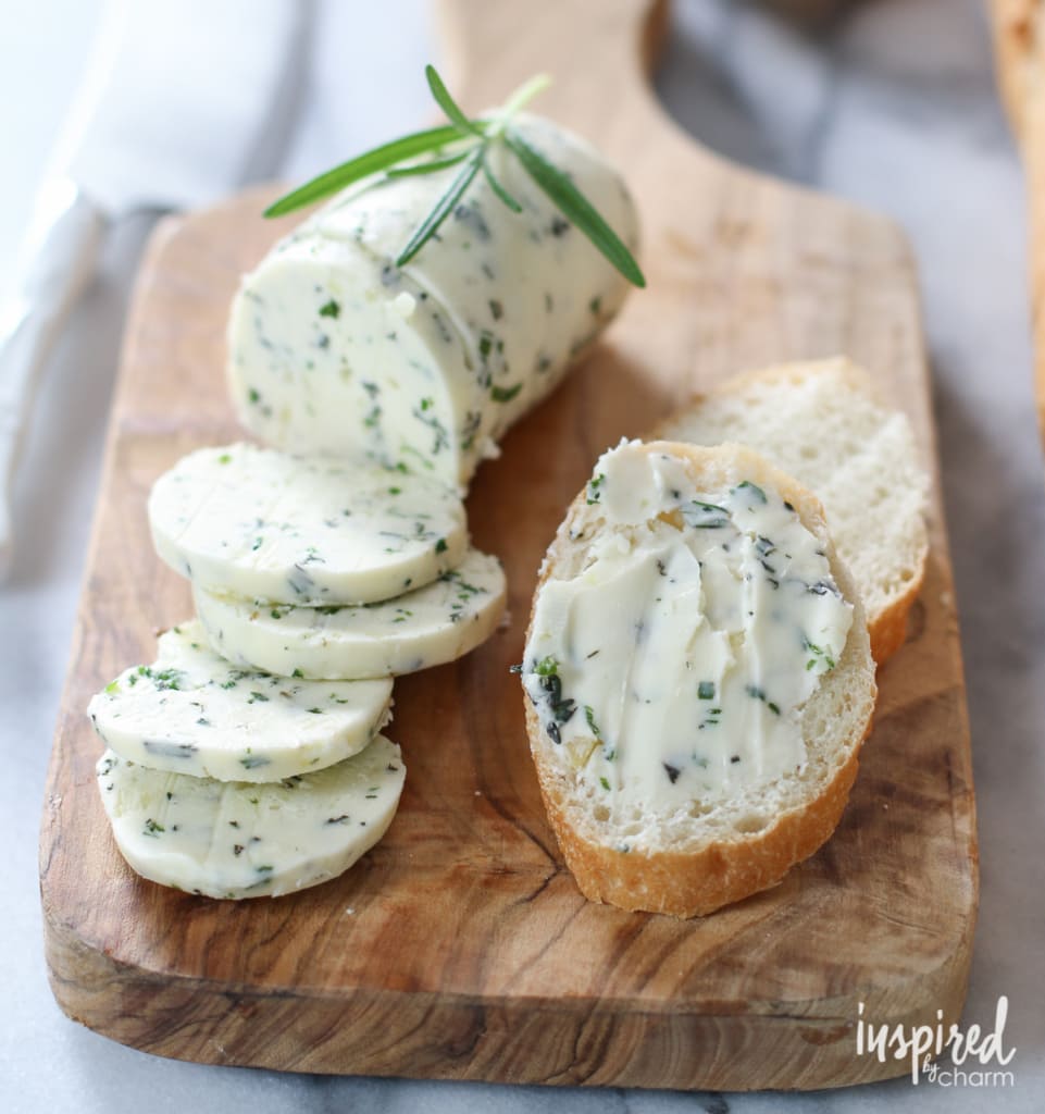 Homemade butter with herbs spread on a slice of bread