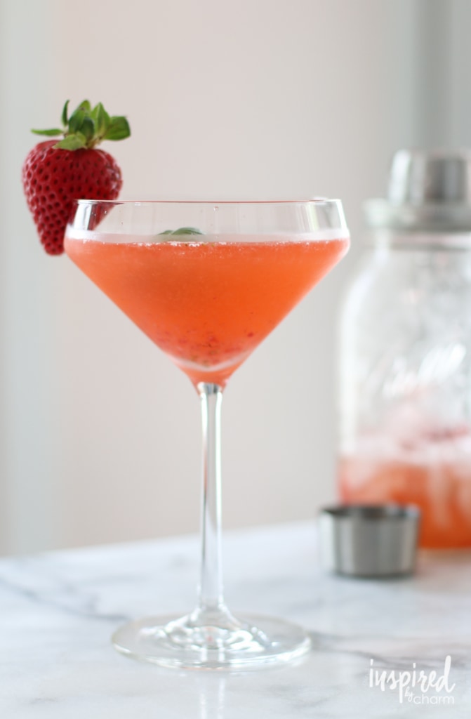 Strawberry Basil Martini in a martini glass with a strawberry garnish.