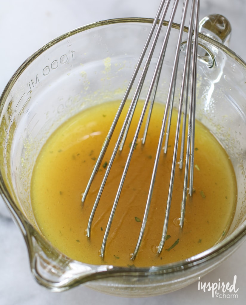 ramen noodle salad dressing in a bowl with a whisk.