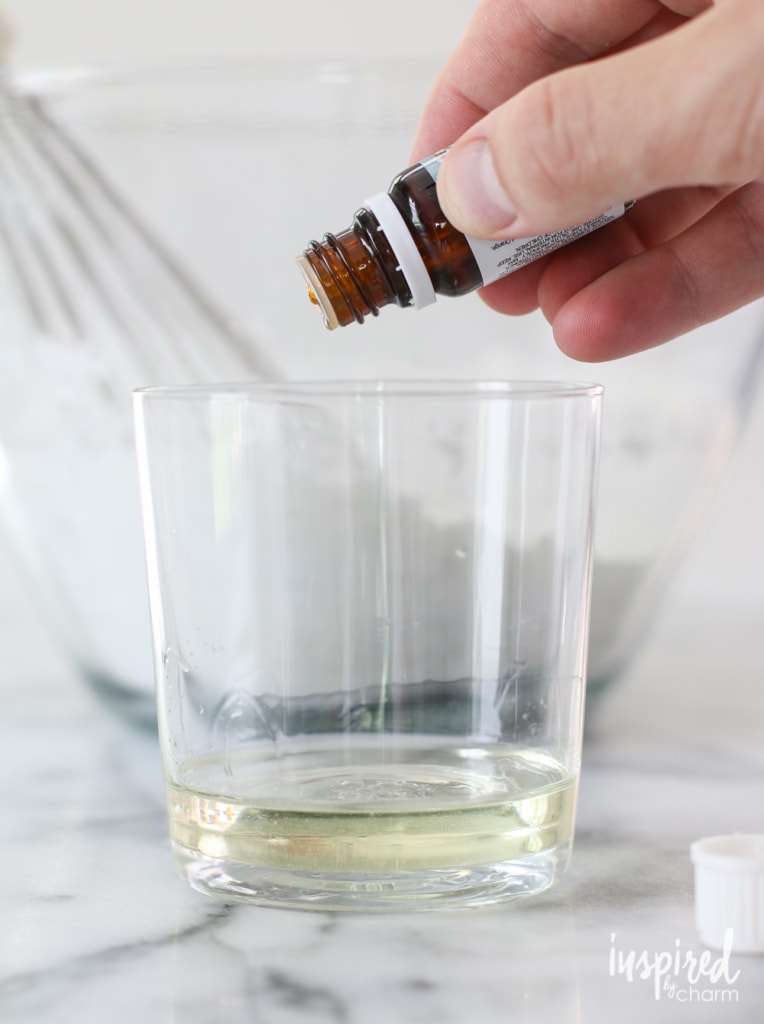 dropping essential oil into a cup