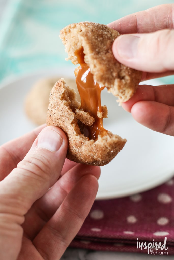 two hands pulling apart a Apple Butter Cookie filled with caramel.  
