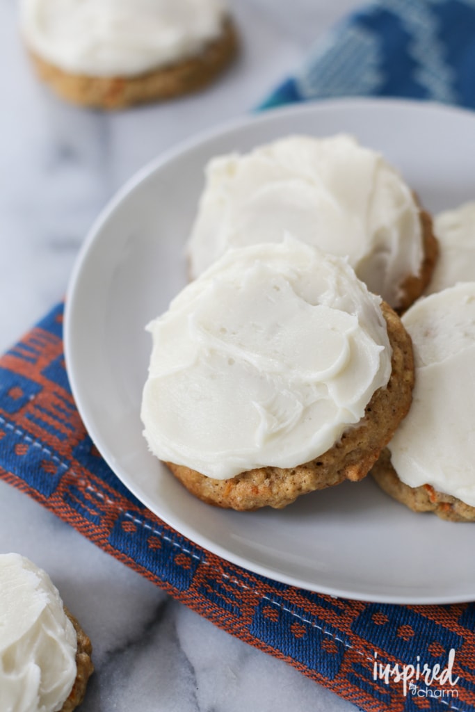 Frosted Carrot Cake Cookies stacked on a plate.