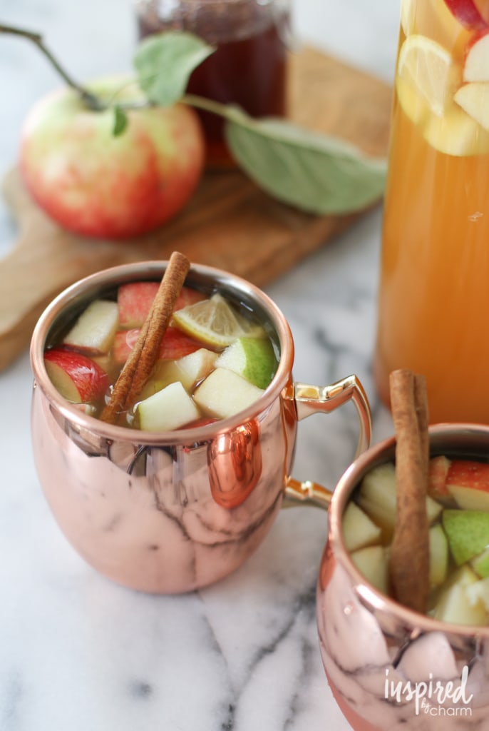copper mug full of apple pie sangria with chunks of apples floating on top