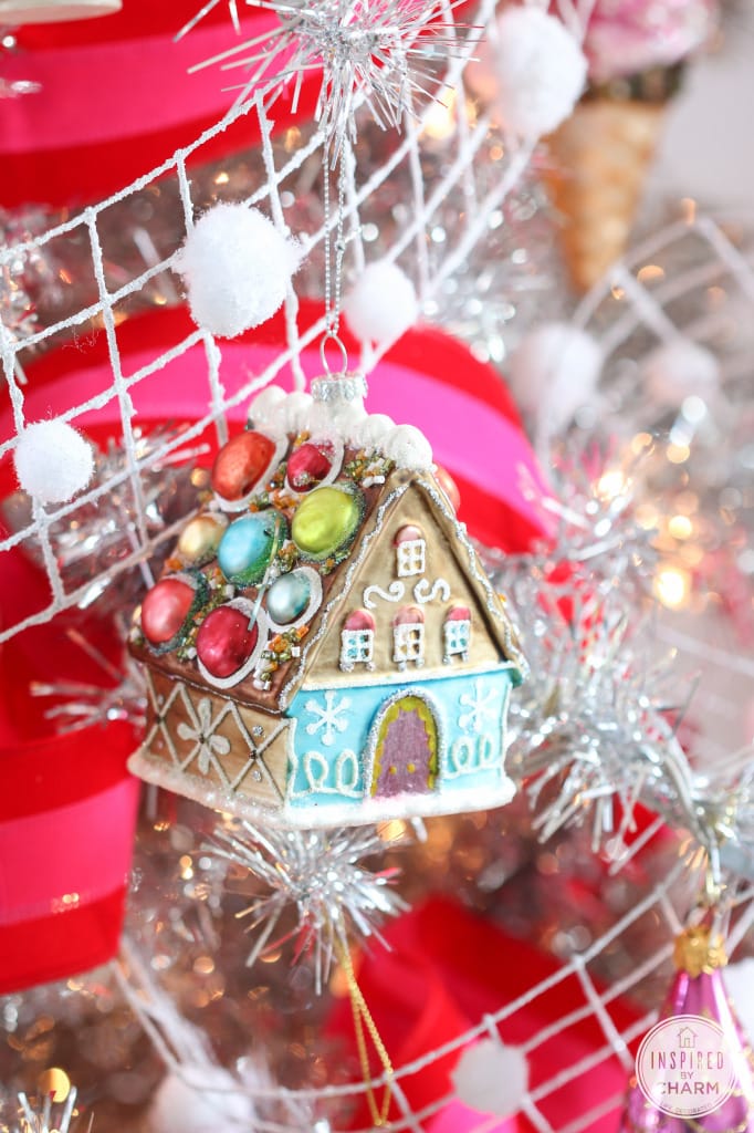 gingerbread house ornament hanging from a branch