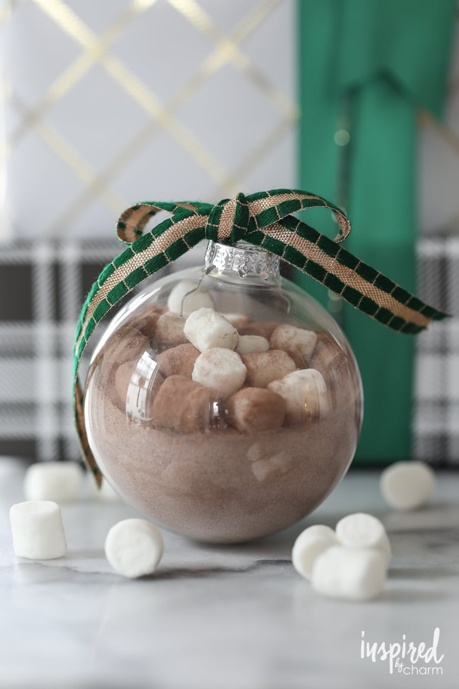 clear glass ornament filled with hot cocoa mix and mini marshmallows