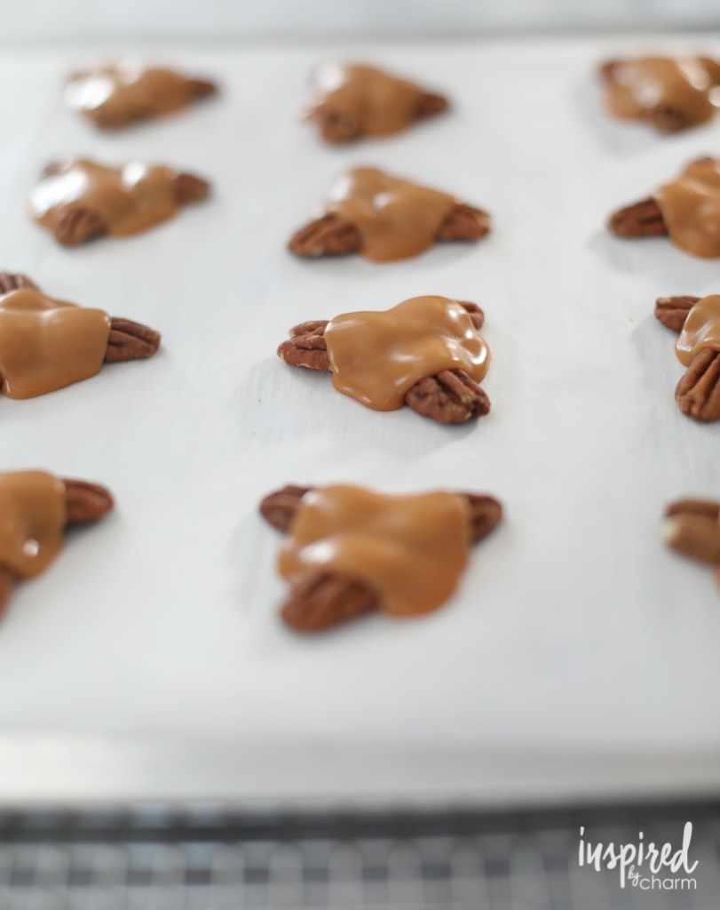 melted caramel over pecans for turtle candy