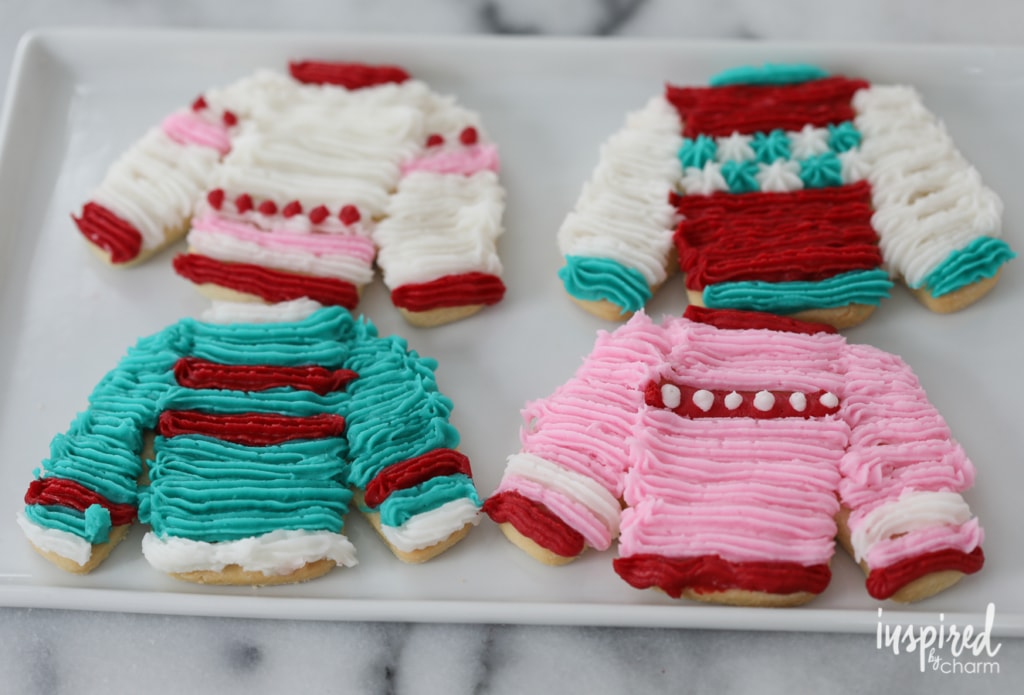 4 colorful sweater sugar cookies on a serving tray