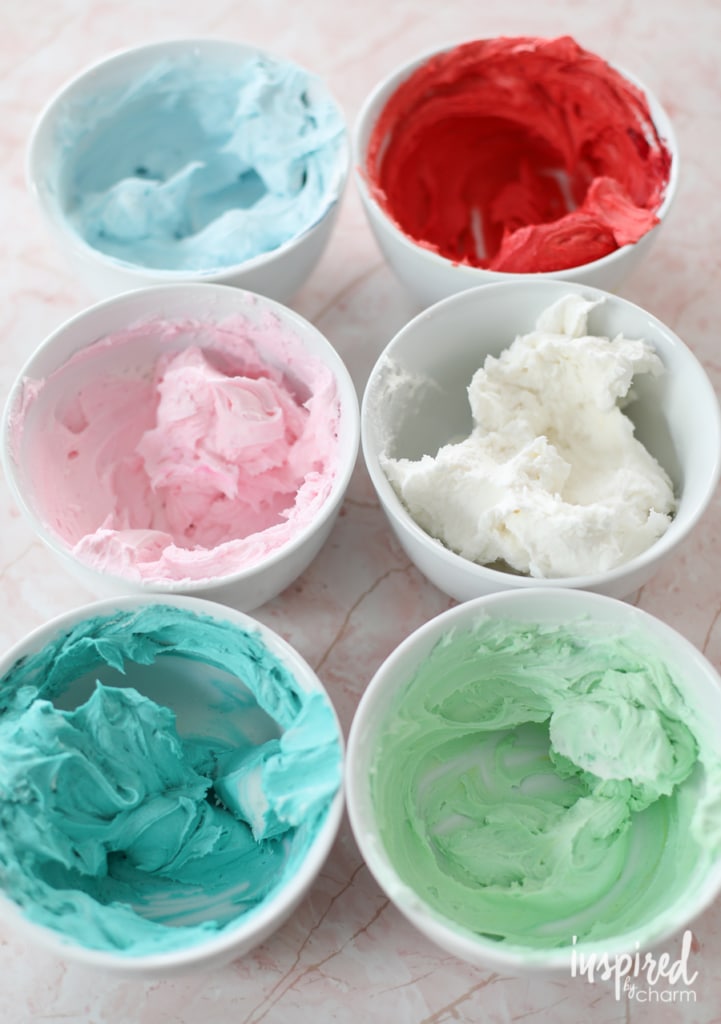 bowls of colored buttercream frosting