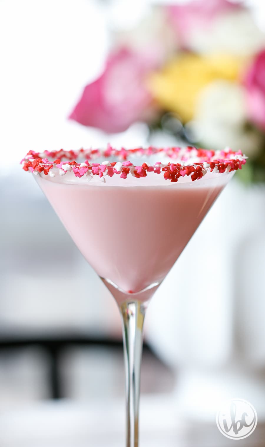 Sweetie Martini in a glass with sprinkles around th rim. 