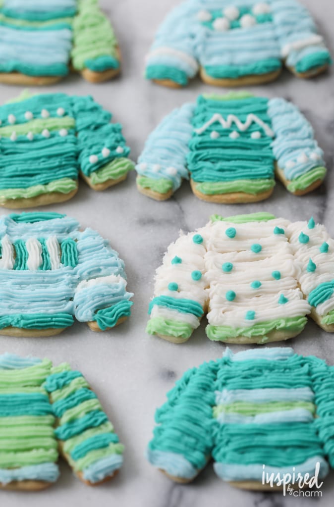 sweater shaped sugar cookies decorated in blue and green icing