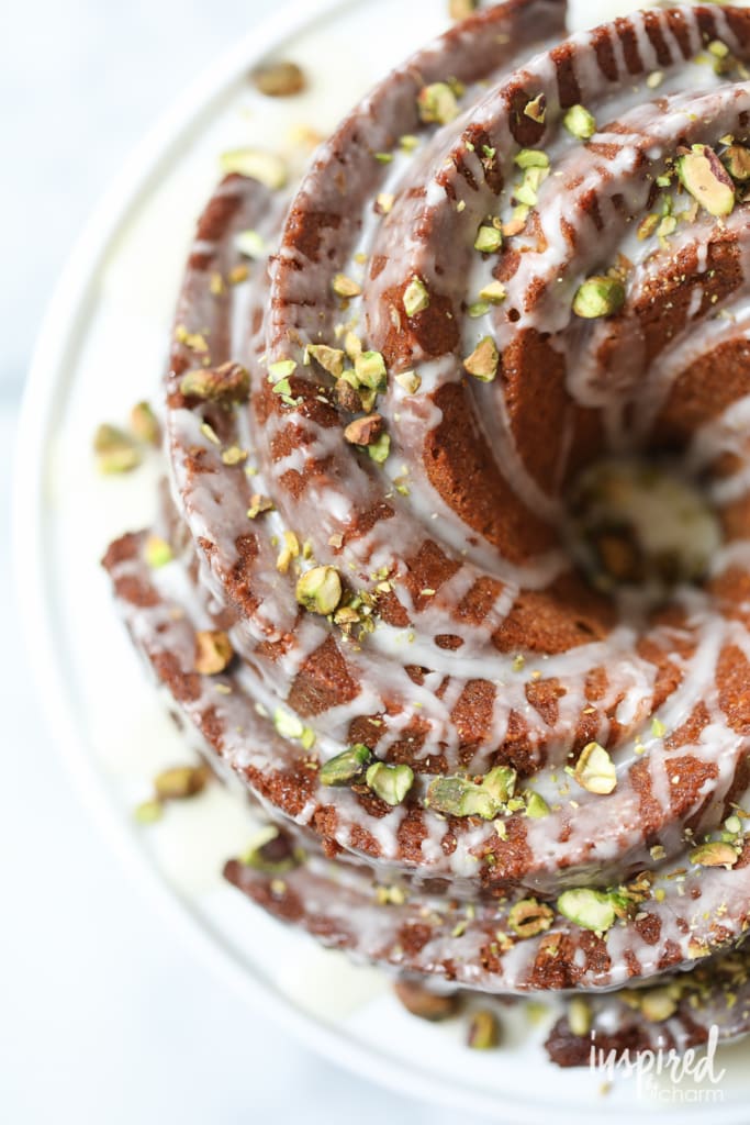 swirled cake with glazed poured over and chopped pistachios sprinkled on top 
