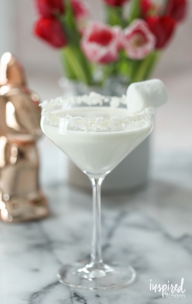cottontail easter cocktail in martini glass with coconut and marshmallow garnish on the rim. 