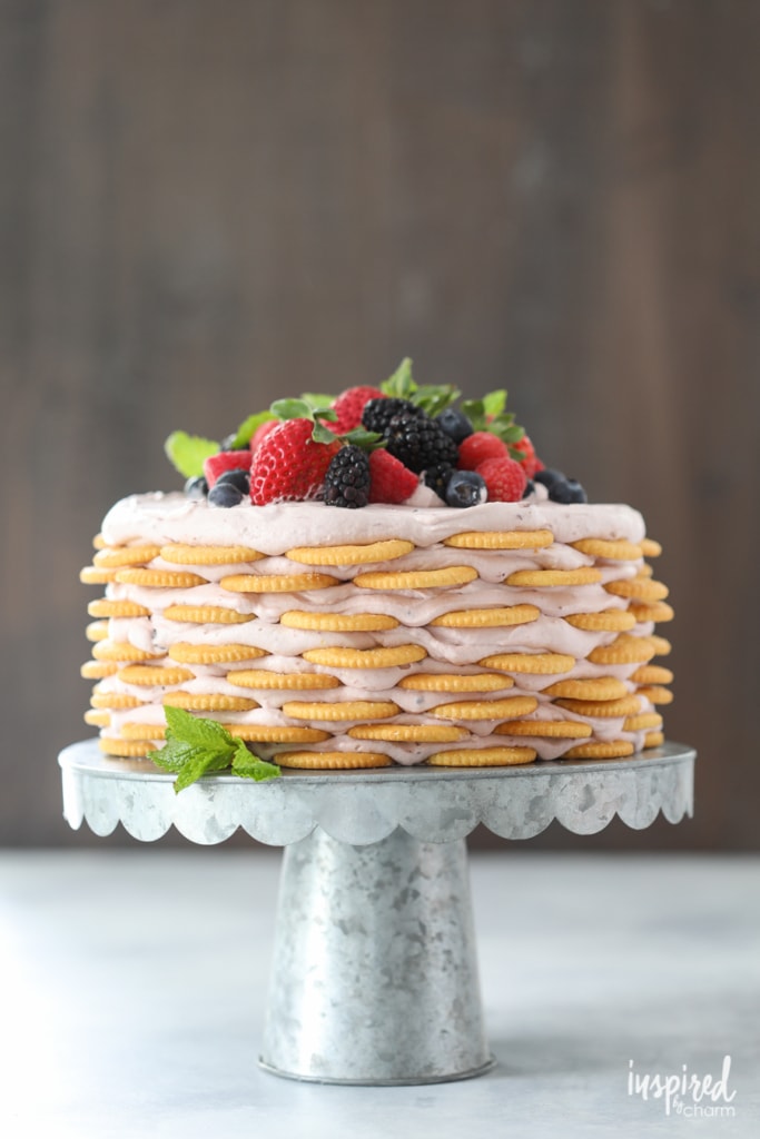 Ritz Cracker and Mixed Berry Icebox Cake on cakes stand.
