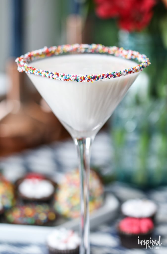 Birthday Cake Martini in a glass with sprinkles around the rim. 
