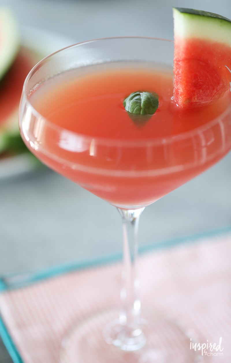 Watermelon Basil Martini in a martini glass with watermelon and basil garnish.