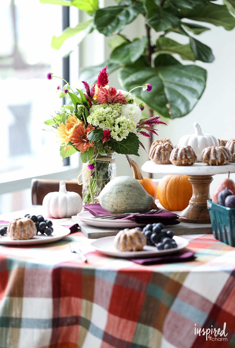 colorful table set for fall with decor and pumpkin muffins.