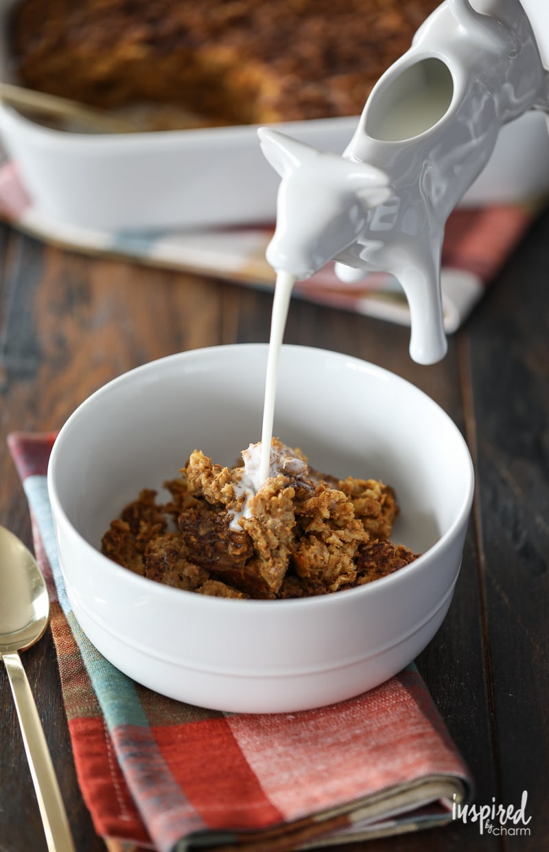 ceramic cow creamer pouring milk over baked pumpkin oatmeal.