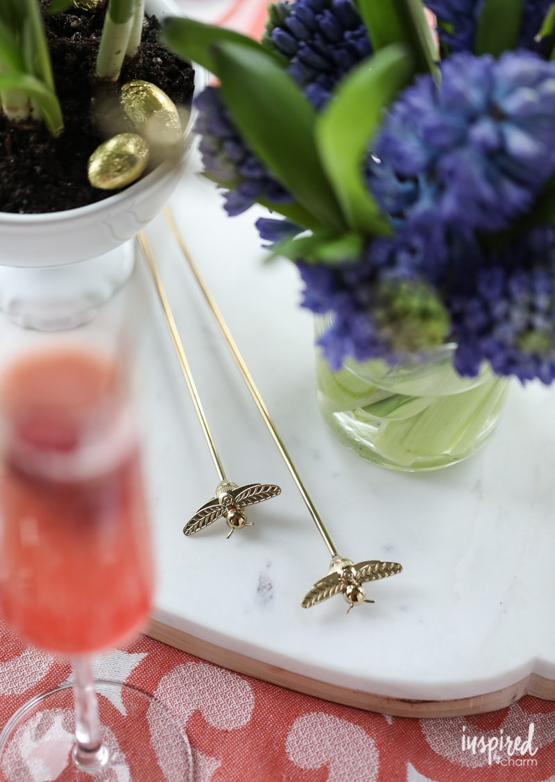This Raspberry Pineapple #Bellini Recipe is a delicious #spring #cocktail #recipe! Gold Honey Bee Cocktail Stirrers 