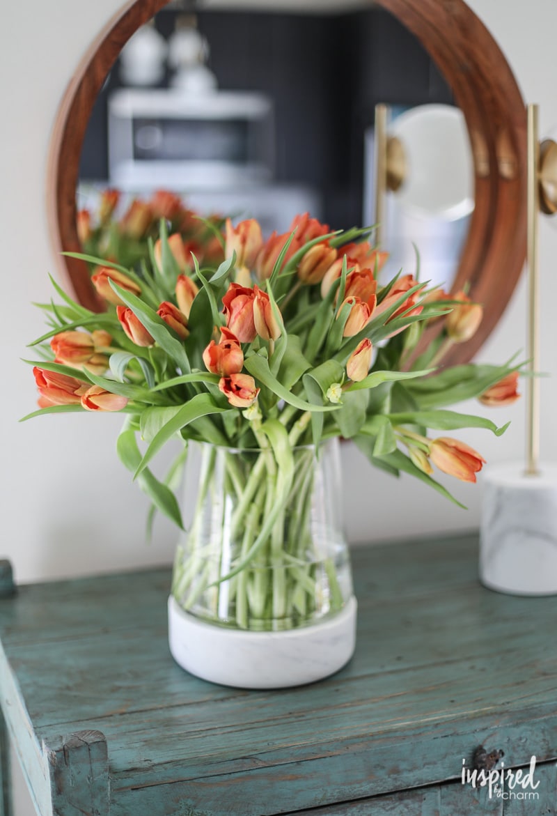 vase of tulips on a cabinet