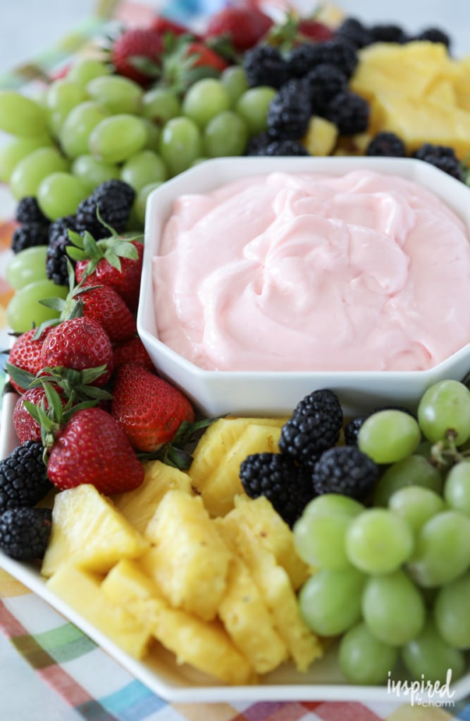 strawberries, pineapple, blackberry and grapes on a tray with fruit dip