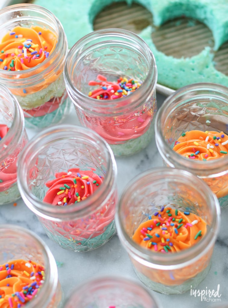 frosting on top of cake in a jar topped with sprinkles