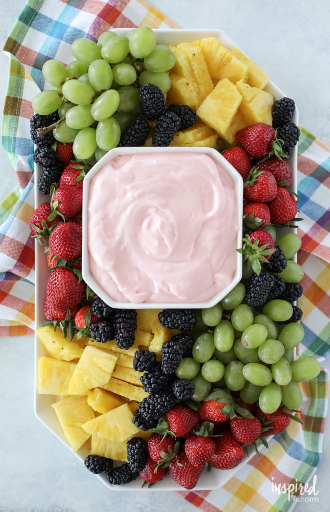 fruit dip in a geometric shaped bowl in the center of a tray of fruit