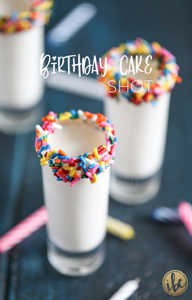 shot glass rimmed with sprinkles filled with a birthday cake flavored shot. 