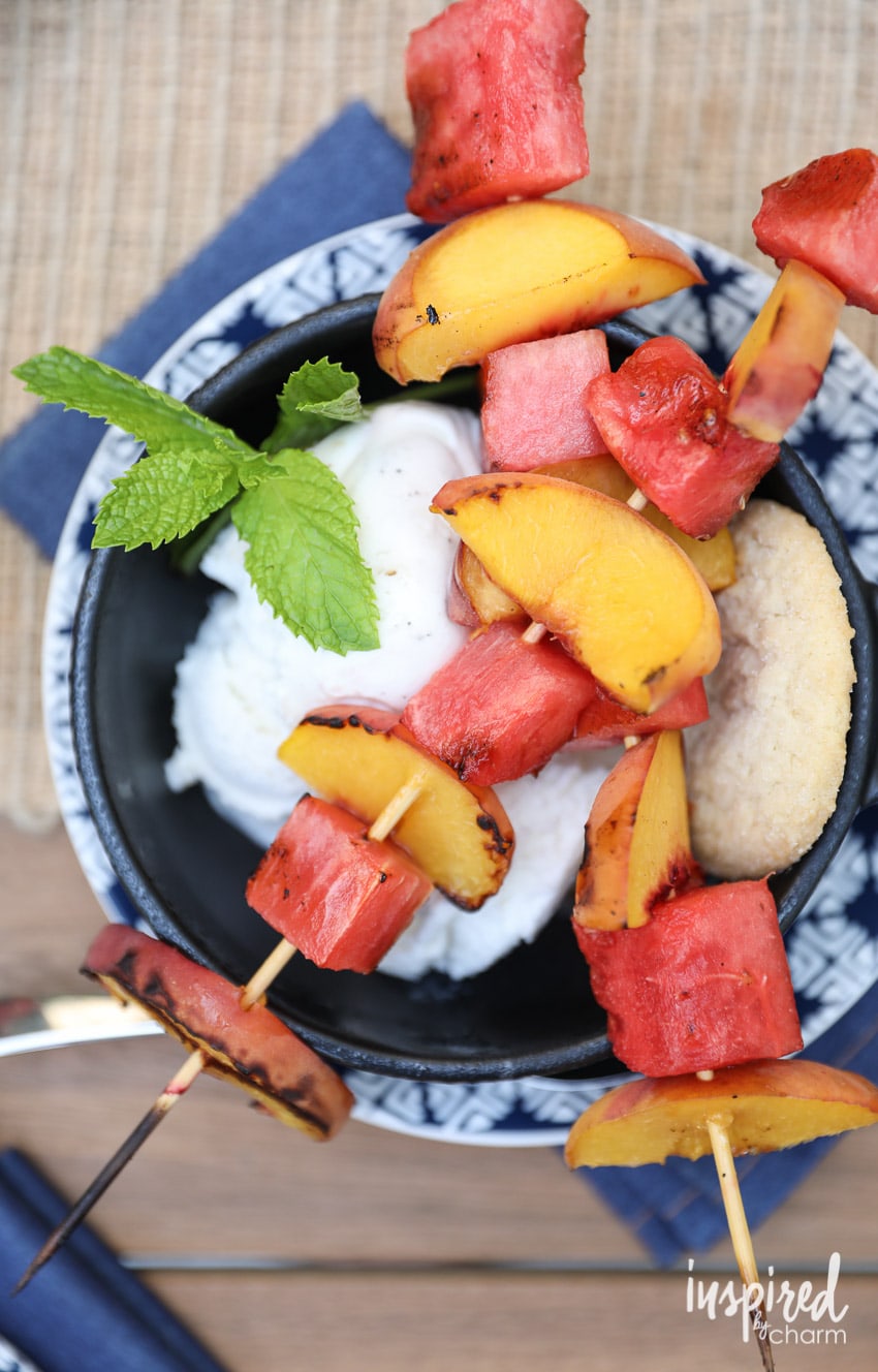 Grilled Peach and Watermelon Kabobs with Ice Cream on a skillet on a plate.