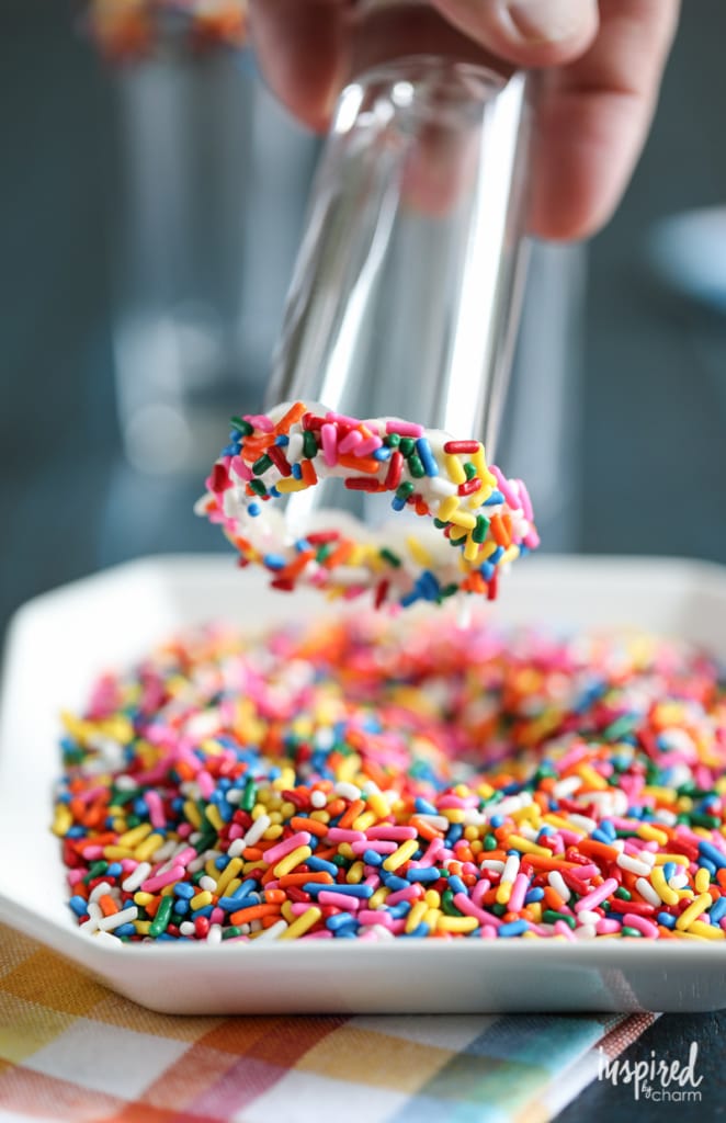 adding sprinkles to the rim of a shot glass. 