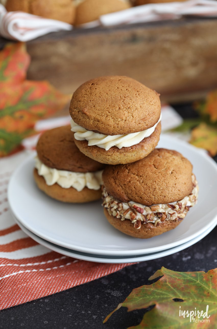 three Pumpkin Whoopie Pies with Salted Caramel Cream Cheese Frosting stated on a plate.