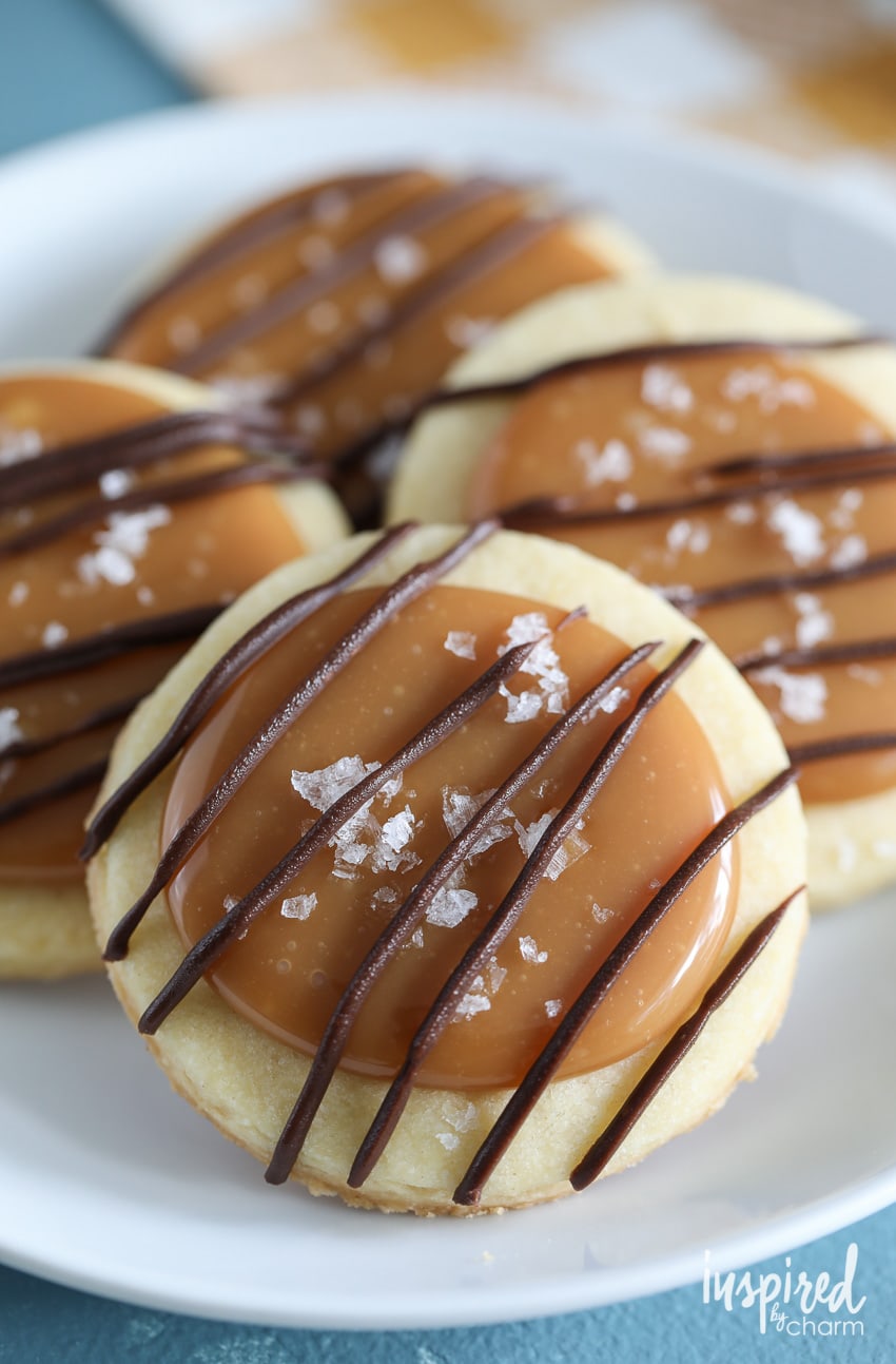 salted caramel shortbread cookies stacked in a pile of four on a plate.
