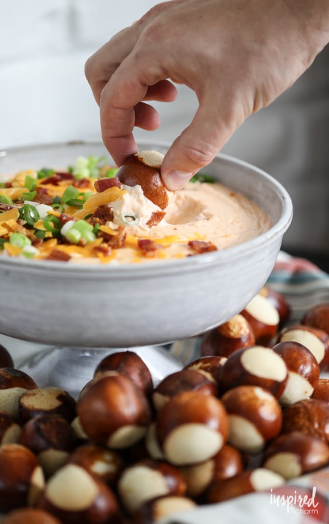Beer Cheese Dip with Bacon in bowl with pretzel bites.