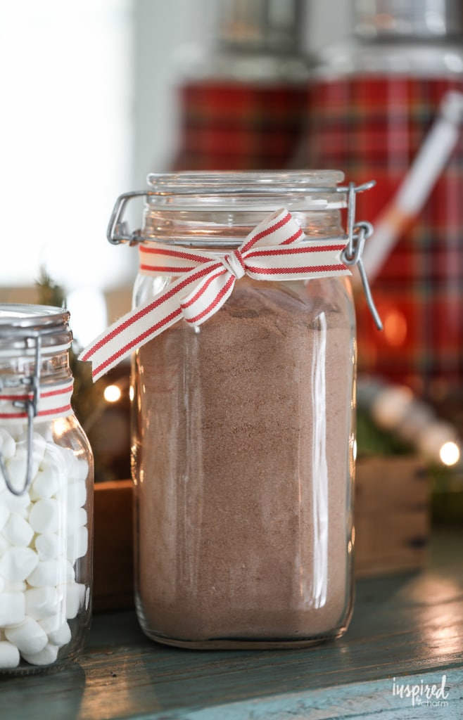 a large jar of hot cocoa mix tied with a ribbon