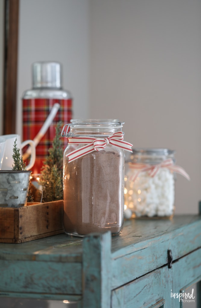 containers of cocoa mix and marshmallows on a decorated table